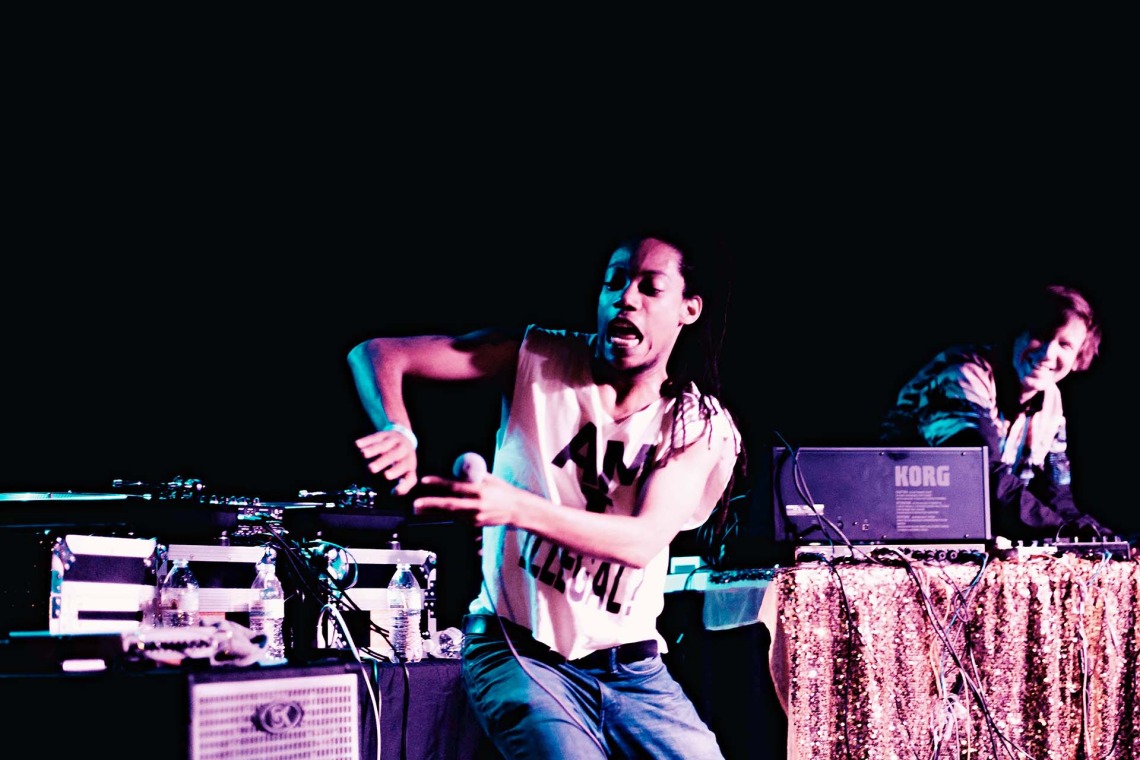 Image of a man performing in front of a crowd.