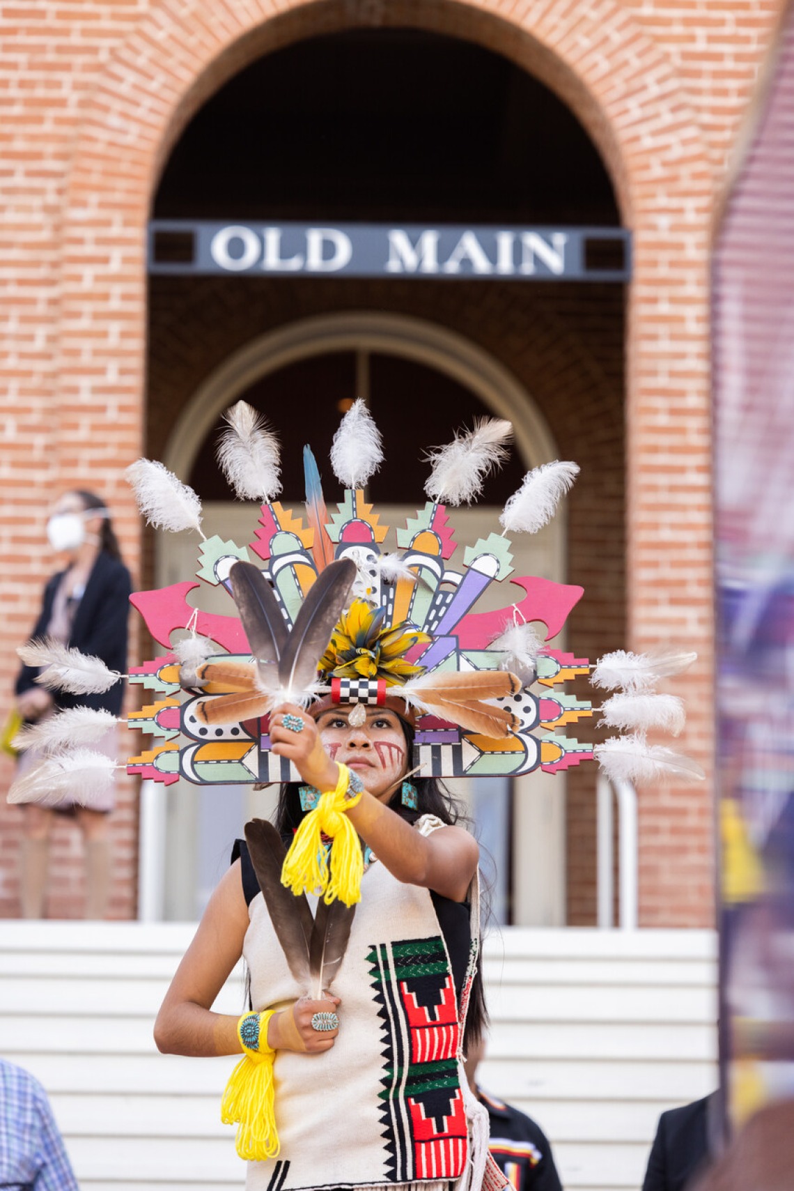 Edith Silas, a Hopi tribal member and the 2022-23 Lori Piestewa Post 80 Princess, performs a ceremonial dance during the unveiling ceremony for a new sign at Old Main in April. The sign describes Old Main as a gathering place in the Hopi language, reading: “Kiisonvi: The focal point of a community where thoughts and prayers become one to benefit all life.” 