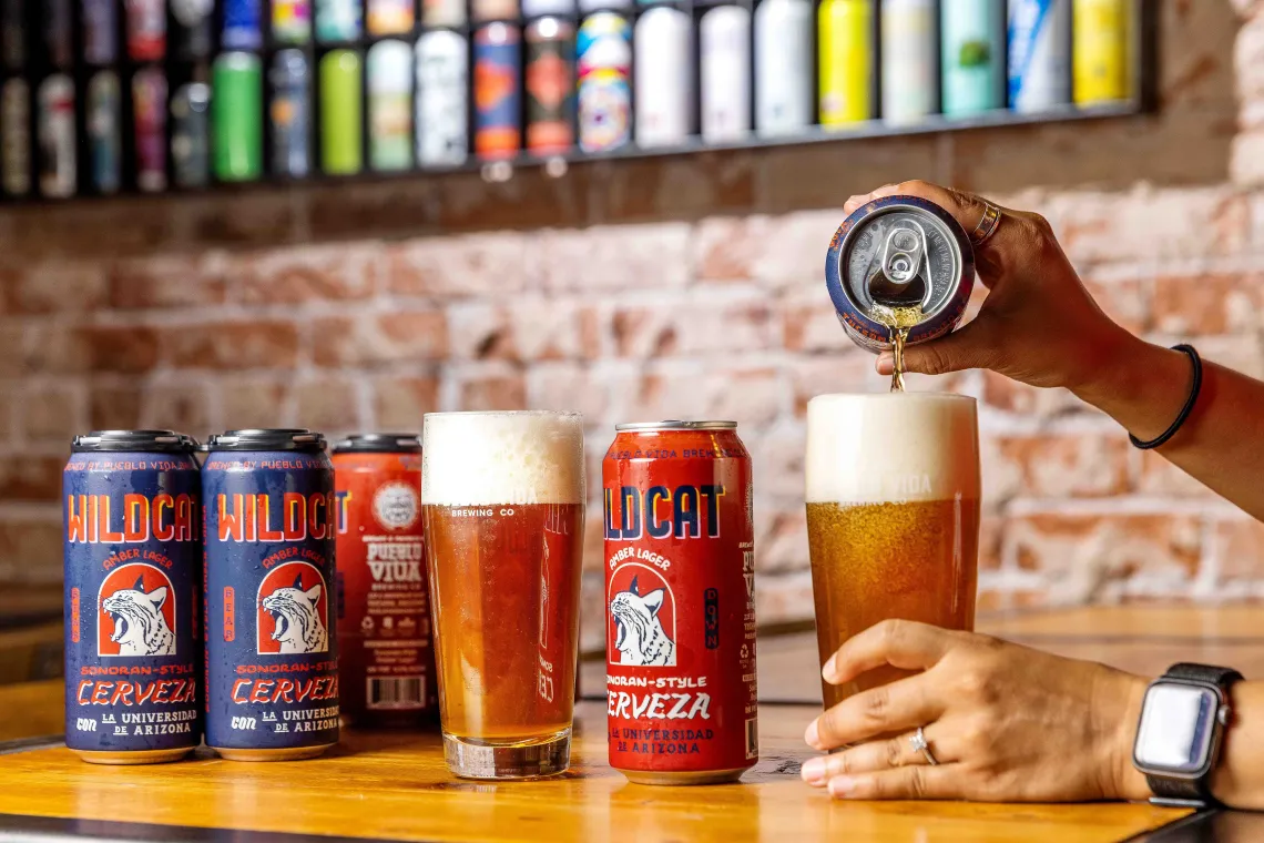 An array of colorful beer cans and pint glasses