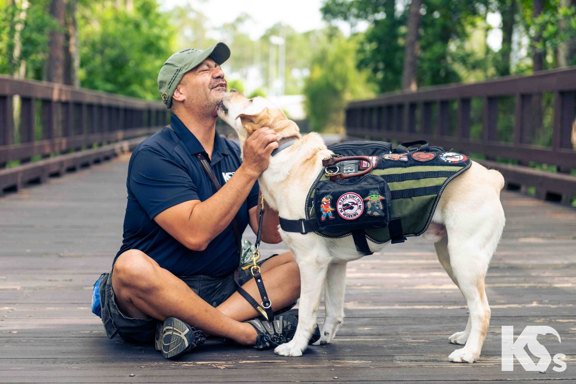 A military veteran  bonds with a  service dog. 