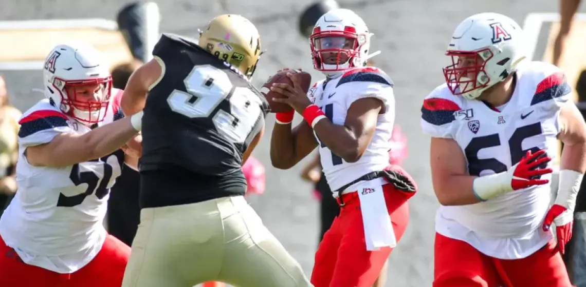 U of A football players playing football with the University of Colorado Boulder 