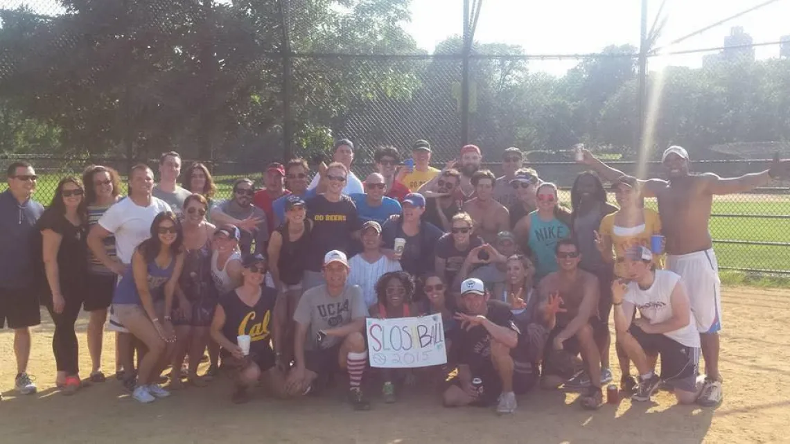 A photograph of players smiling while holding a sign that reads "Shloshball 2015"