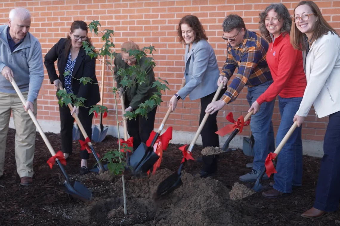 Images of members of the Flandrau Science Center and Planetarium planting the Artmeis I moon tree.