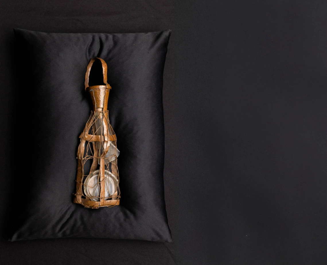 Bottle on black pillow