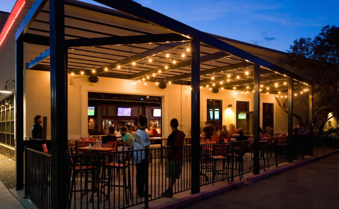 Around 12 people standing and talking at Craft Republic's Patio
