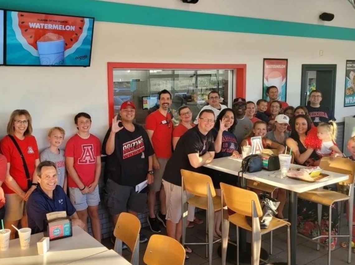 A group of people wearing Arizona Wildcat gear at Eegee's