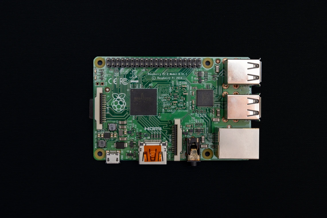 An image of the Raspbery Pi computer that is the size of a credit card. The Raspbery Pi has a forest green base with a typical computer circuit board visible on top.