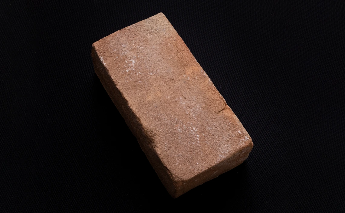 A red brick against a black background