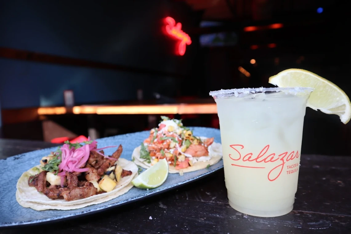 An image of two carne asada tacos with toppings next to a margarita from Salazar DC resturant in Washington D.C. 