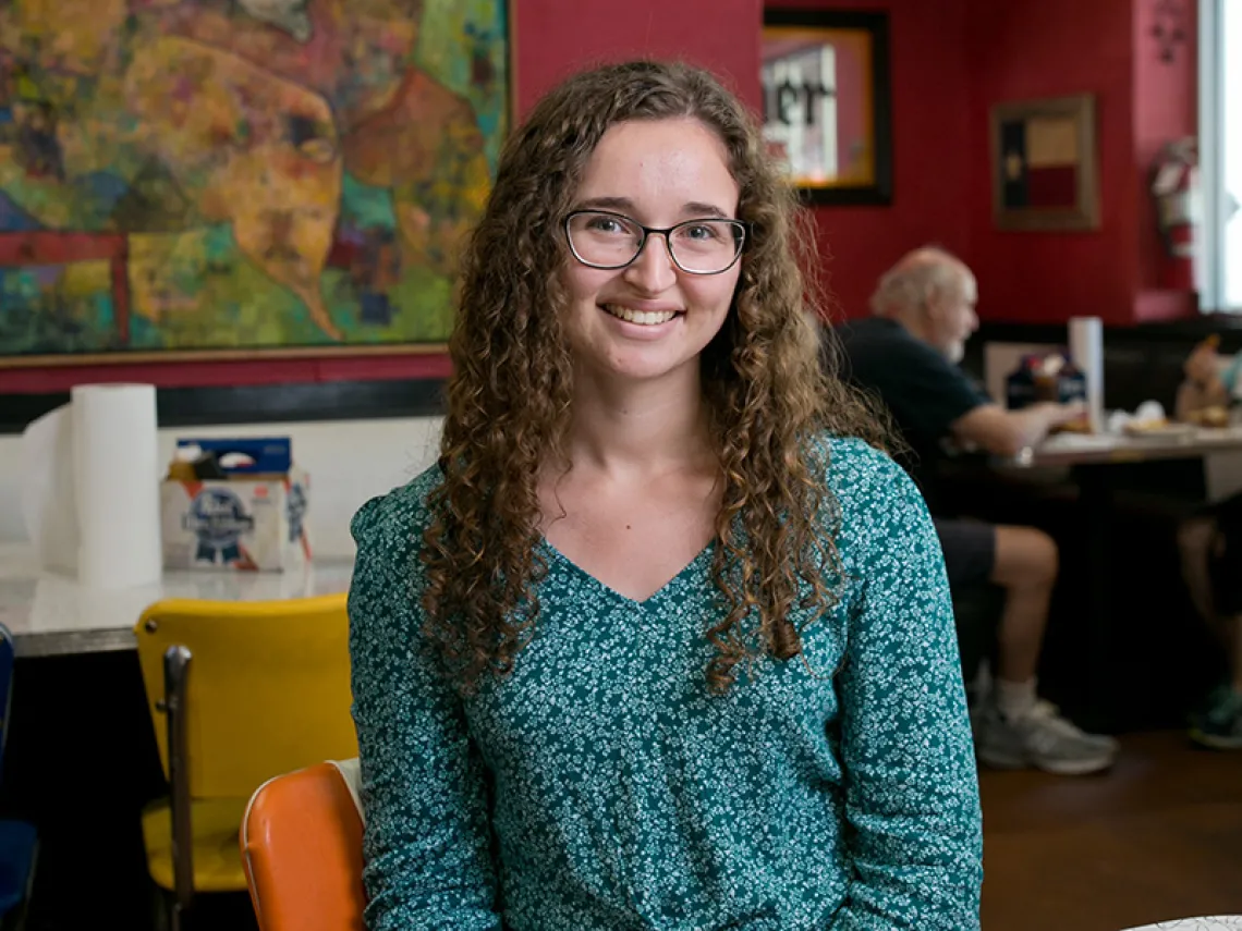 A photograph of Adriana Stohn sitting and smiling