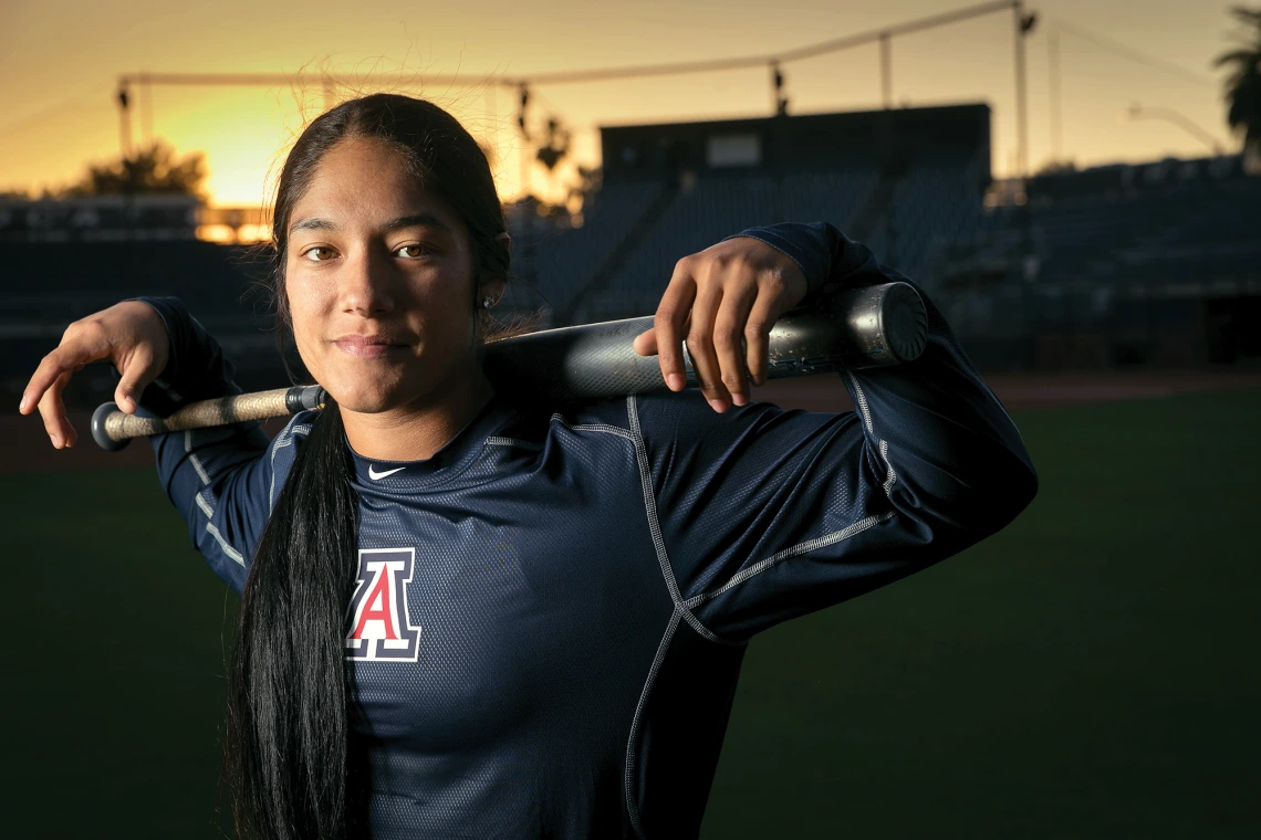 A photograph of Alyssa Palomino holding a baseball bat