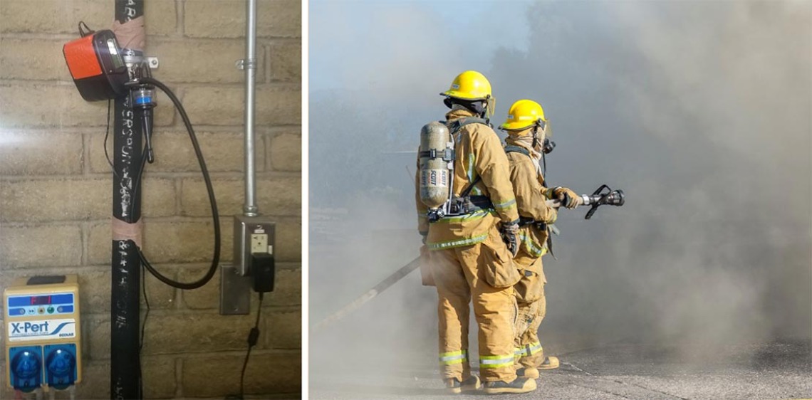 A photograph of firefighters using a hose filled with water to put out a fire