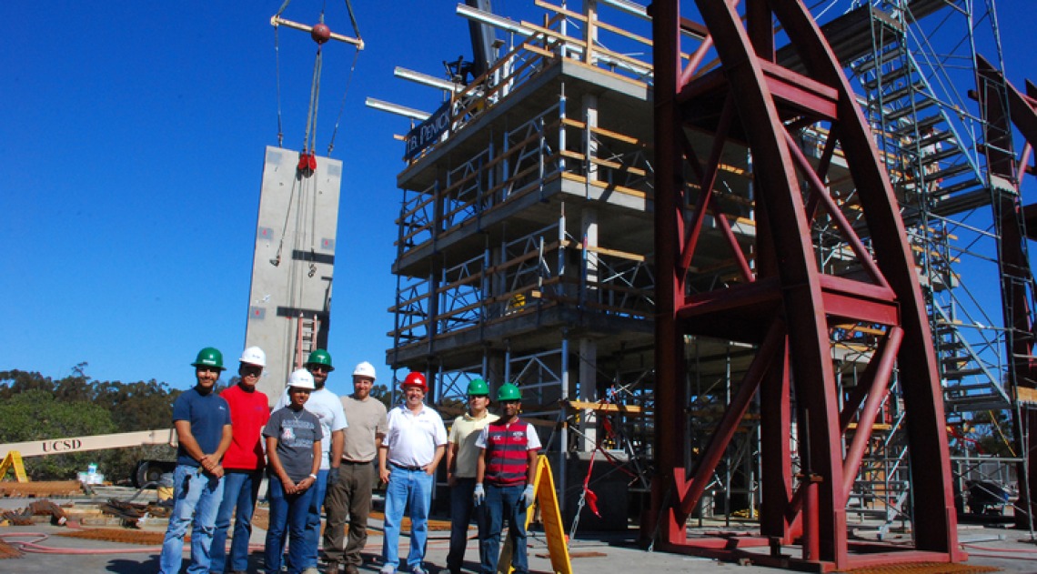 A photograph of Robert Fleischman and members of the research team wearing hardhats at a site.