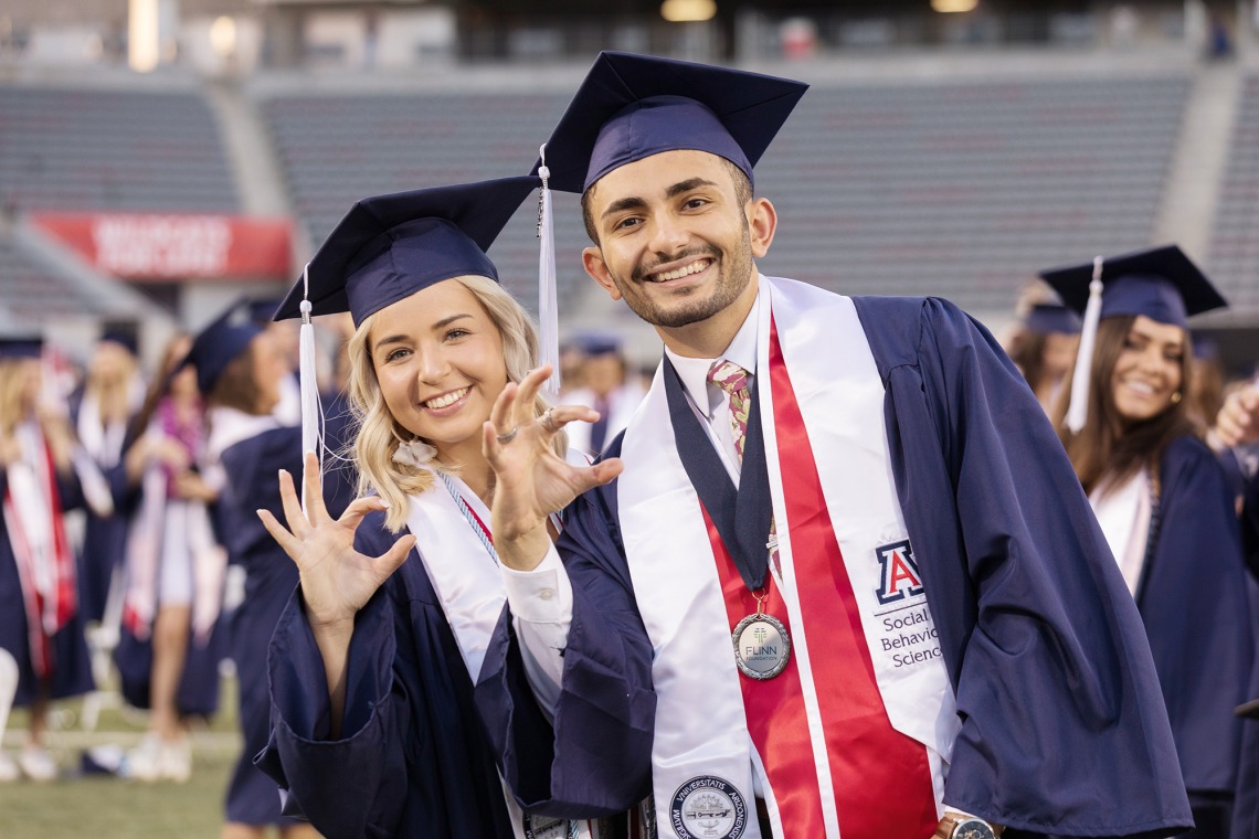 A photograph of two University of Arizona students on Graduation Day. 