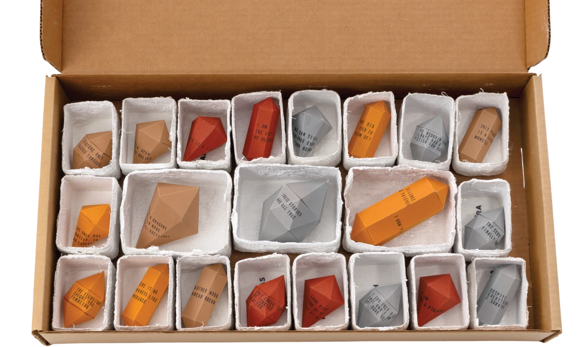 Box containing 21 origami gemstones