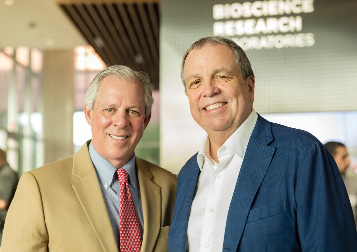 A photograph of President Robert C. Robbins and Michael Dake standing and smiling