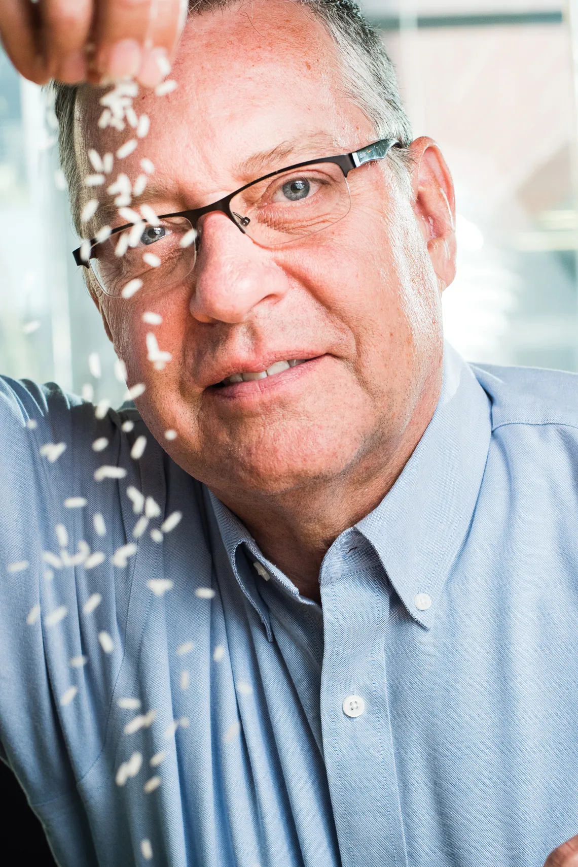 A photograph of Rod Wing tossing rice 