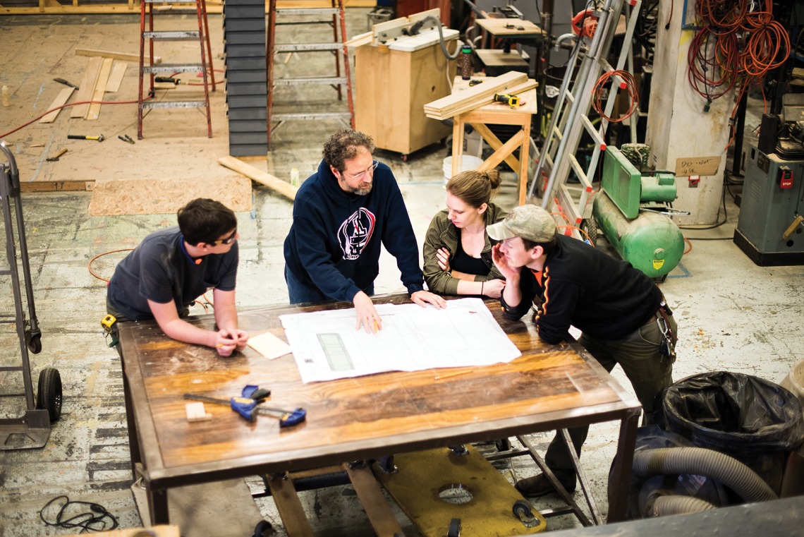 Graduate students Dan Movick (left), Jack Meng (far right) and Ruth Richardson review set design plans for “Twelfth Night” with Assistant Professor and Technical Director Ted Kraus.