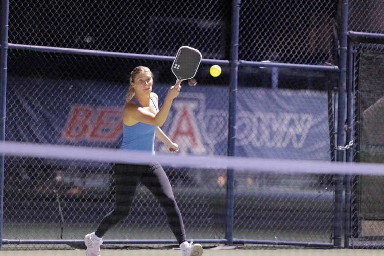 Kira hitting a ball on the court