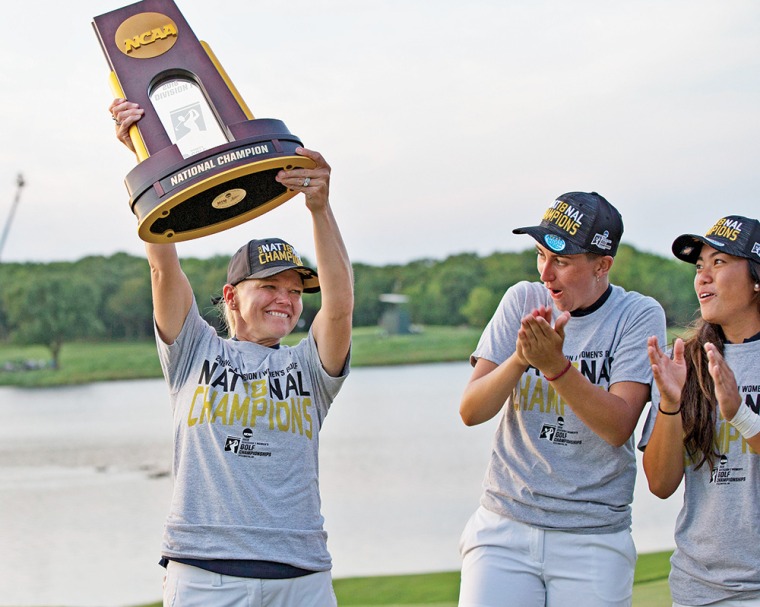 A photograph of UA Women's golf coach, Laura Ianello holding the trophy