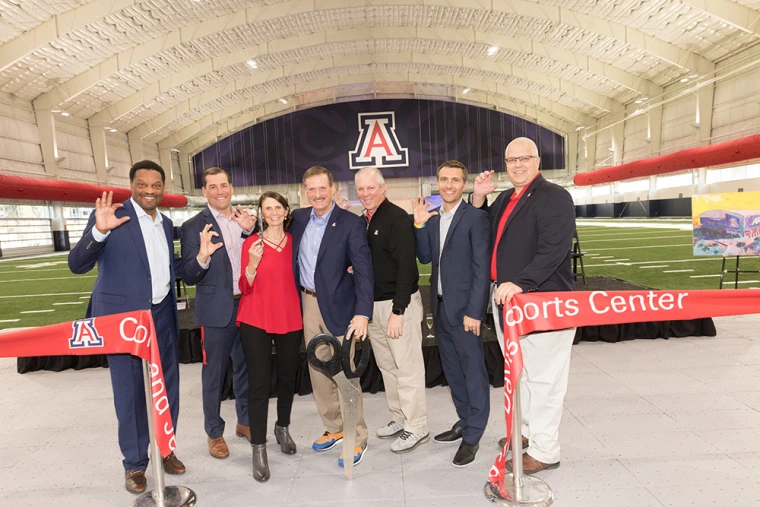 A photograph of the ribbon-cutting event with the Davis family, Kevin Sumlin, Dave Heeke and President Robert C. Robbins