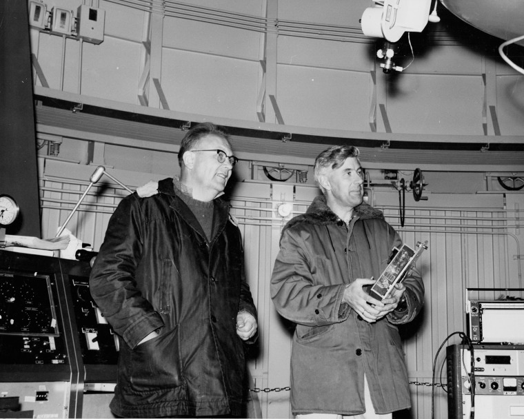 A photograph of Gerard Kuiper and Ewen Whitaker in the dome of a telescope on Mount Bigelow 
