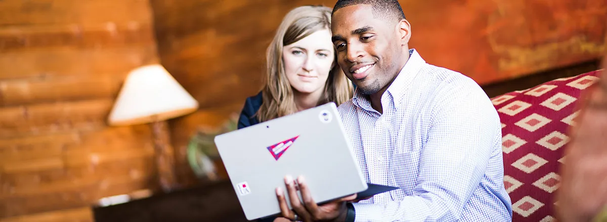 Man and woman looking at iPad