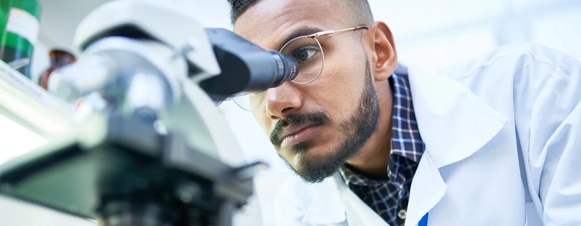 Man looks into microscope