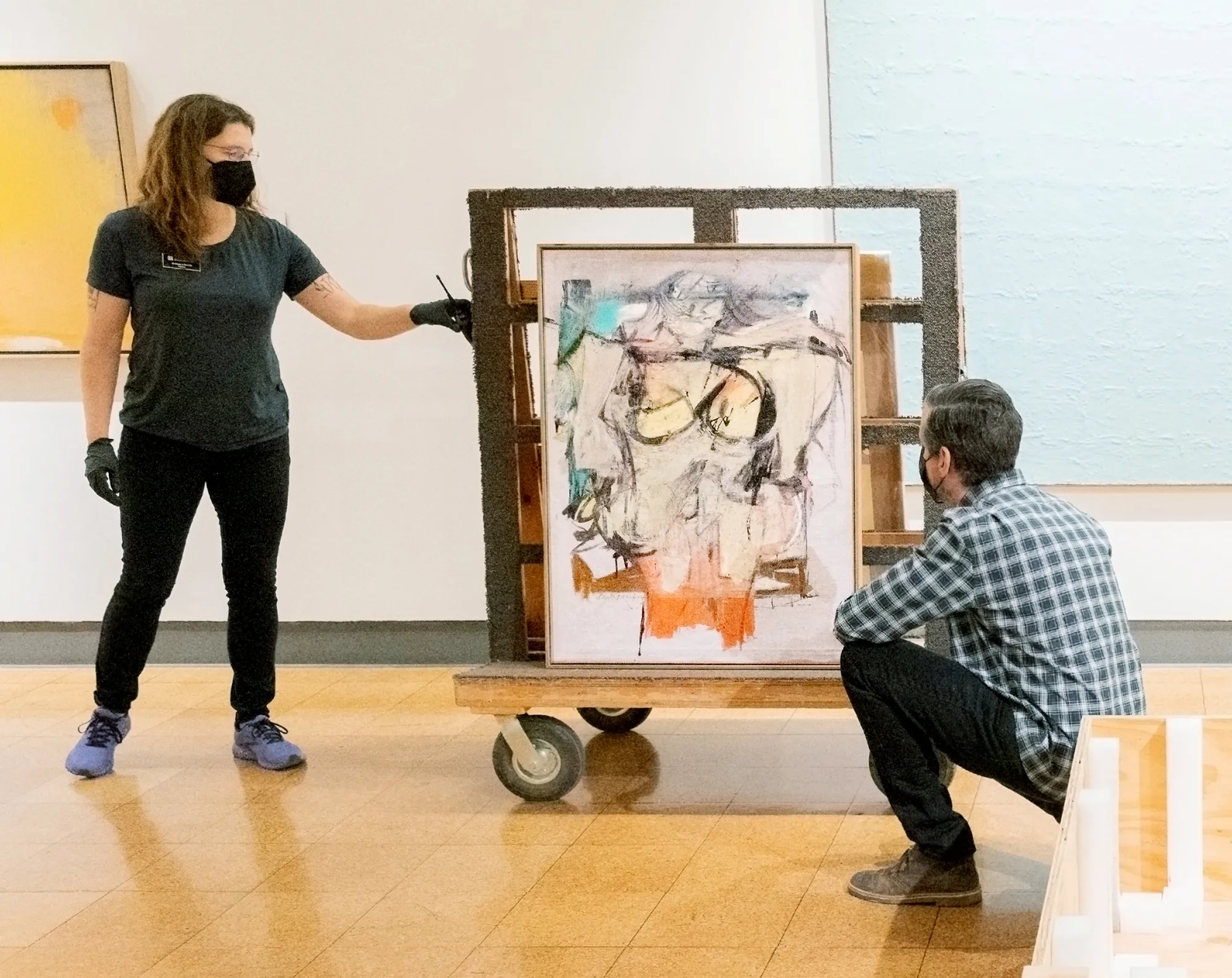 Two workers looking at painting