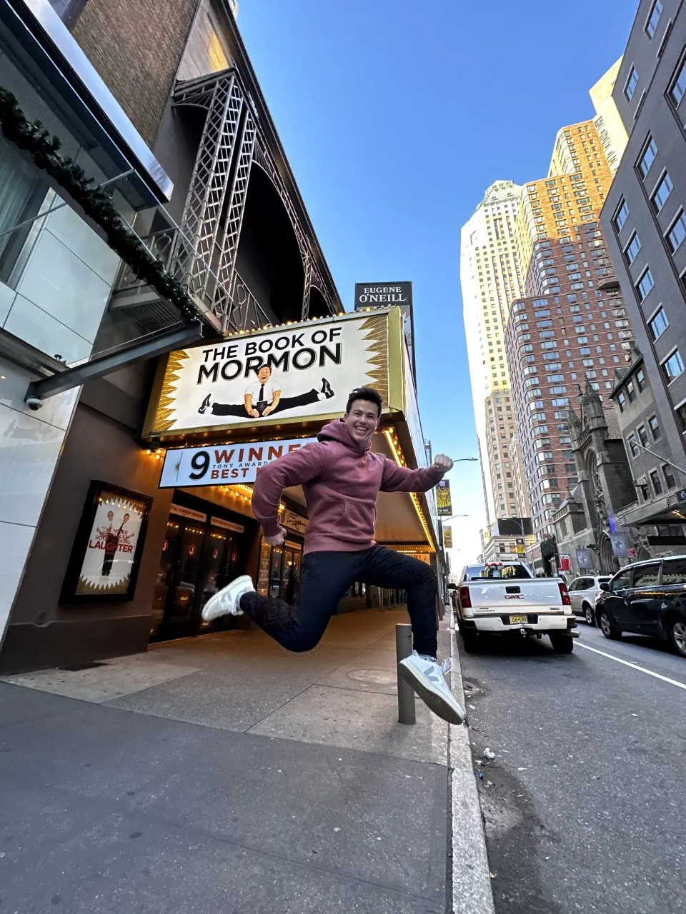 A photograph of Tony Moreno '21 in front of "The Book of Mormon" at the Eugene O'Neill Theatre in New York City.