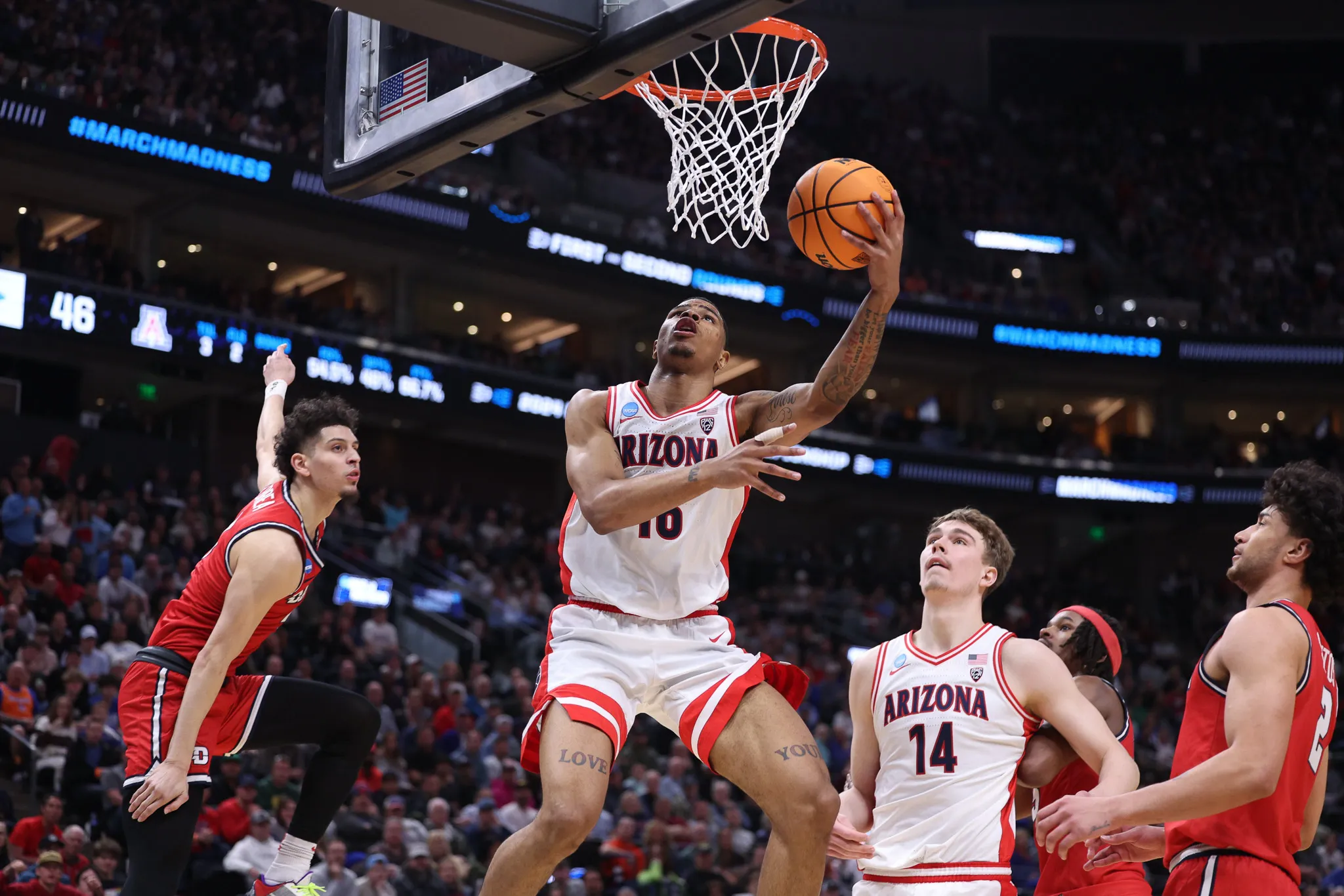 Keshad Johnson lays in 2 points while teammate Motiejus Krivas looks on vs. Dayton in the NCAA Tournament