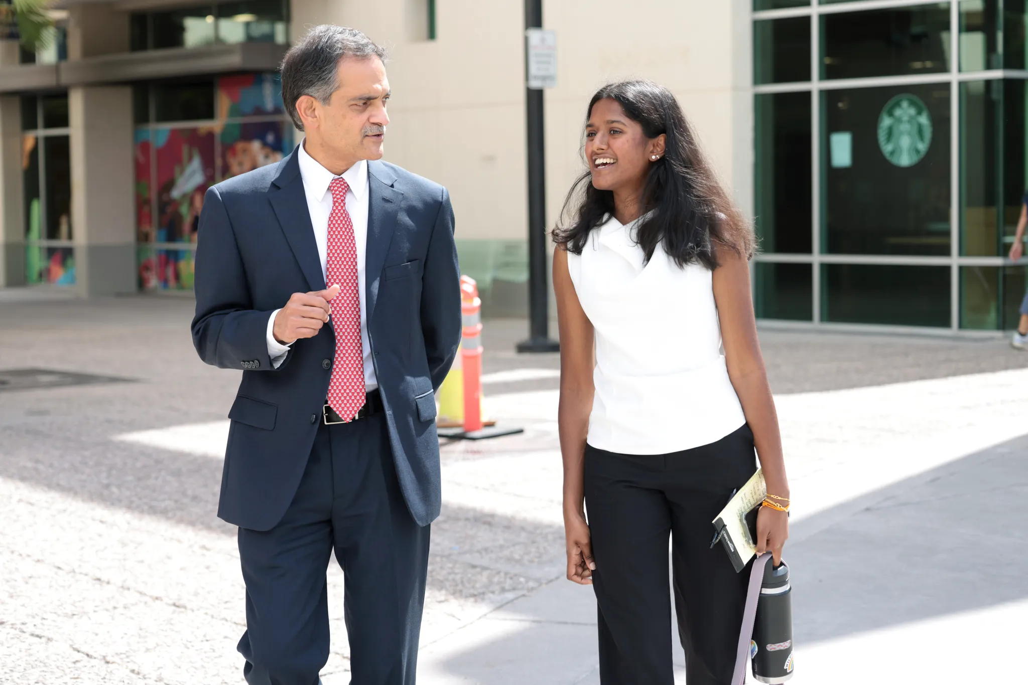 University of Arizona President, Suresh Garimella, walking and talking with Arizona Daily Wildcat reporter Kanishka Chinnaraj near the Student Union Memorial Center.