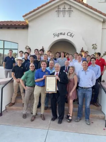 Group photo in front of Sigma Chi