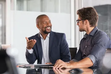 Two people talking in an office