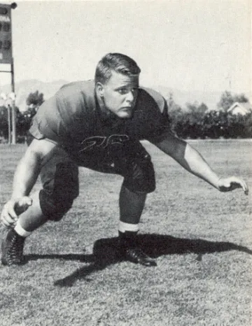 Black and white photo of a football player in the 1950s