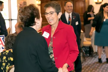 Two women greet each other