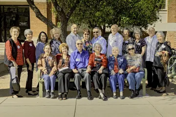 Group of people sitting on a bench on campus