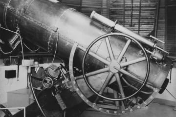 A photograph of Dr. Edwin Carpenter and the "All-American" telescope 