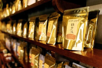 Bags of packaged tea on wooden shelf