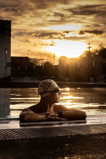 A portrait of a swimmer in profile at sunset