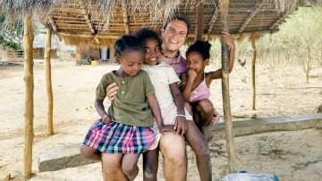 Image of David Morales with children and students from Madagascar.