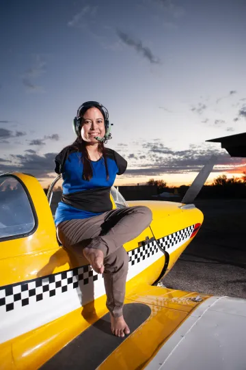 Image of Jessica Cox sitting on top of airplane.