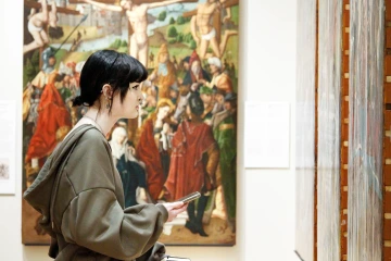 Woman looking at the Altarpiece artwork in University of Arizona Museum of Art