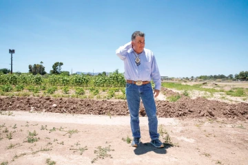 A photo of N. Levi Esquerra in front of his field.