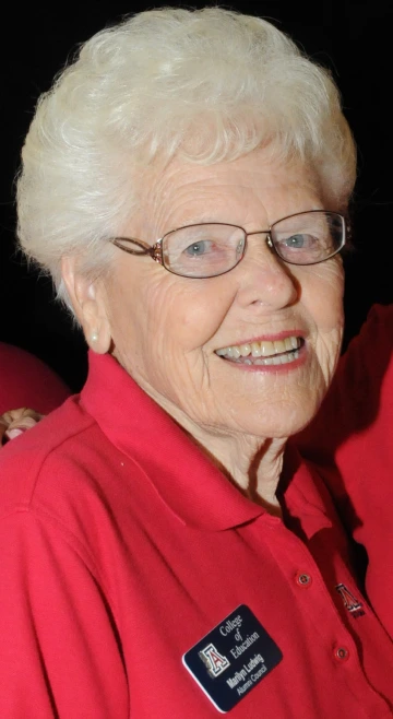 Marilyn smiling, wearing a red polo and a College of Education polo 