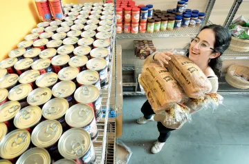 A photography of a student carrying a loaf of bread into the Campus Pantry