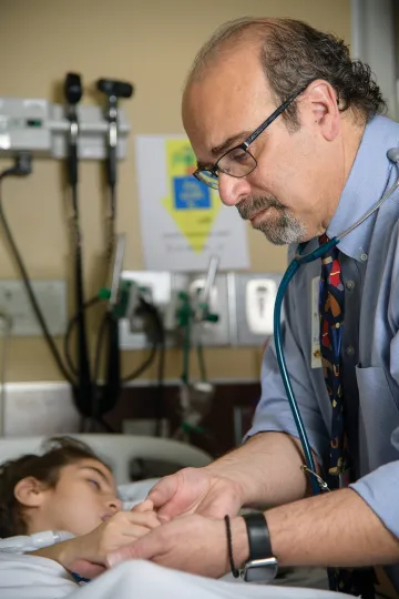 A photograph of Dr. Andreas “Andy” Theodorou and his patient, Ariana