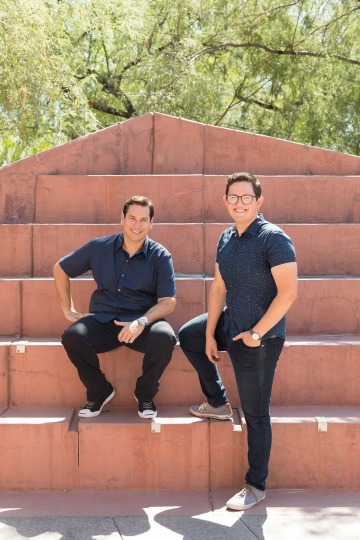 A photograph of Carlos Chavez and Cisco Aguilar sitting outside the Student Union Memorial Center