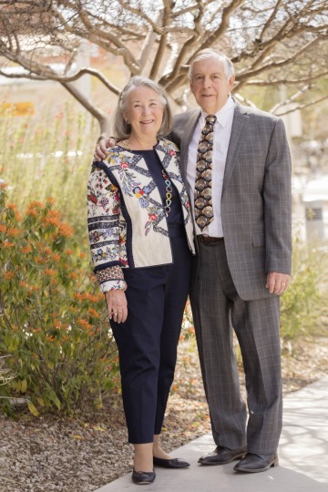 A photograph of Patricia and Bruce Bartlett smiling and standing 