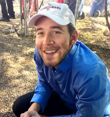 A photograph of Clayton Kammerer sitting 